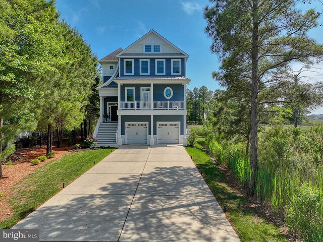 169 E Buckingham Dr, Rehoboth Beach, DE 19971 - beach home with stairs, concrete driveway, a garage, a porch, and metal roof