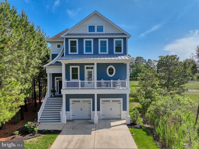 169 E Buckingham Dr, Rehoboth Beach, DE 19971 - beach home with stairs, covered porch, concrete driveway, and an attached garage