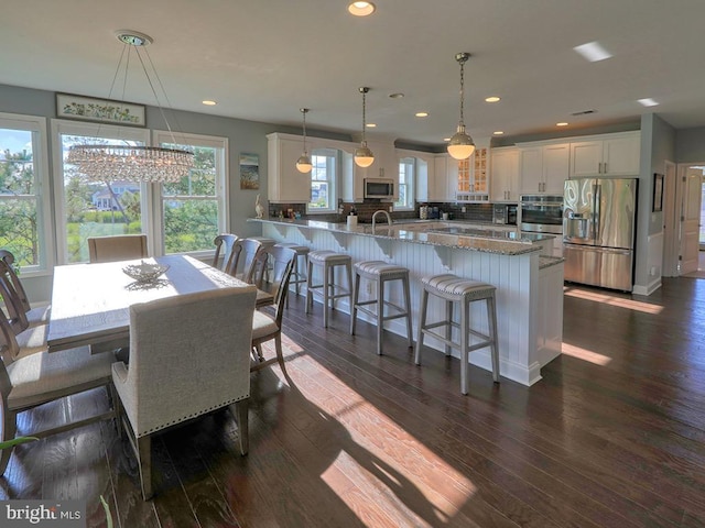 169 E Buckingham Dr, Rehoboth Beach, DE 19971 - dining space with dark wood-type flooring, a chandelier, and recessed lighting
