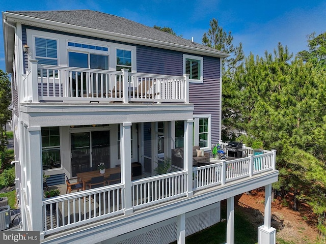 169 E Buckingham Dr, Rehoboth Beach, DE 19971 - rear view of house featuring a balcony and a shingled roof