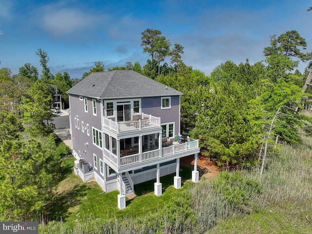 169 E Buckingham Dr, Rehoboth Beach, DE 19971 - rear view of house with a shingled roof, a deck, stairs, and view of wooded area