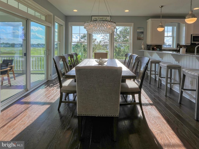 169 E Buckingham Dr, Rehoboth Beach, DE 19971 - dining space with dark wood-style flooring, a chandelier, and recessed lighting