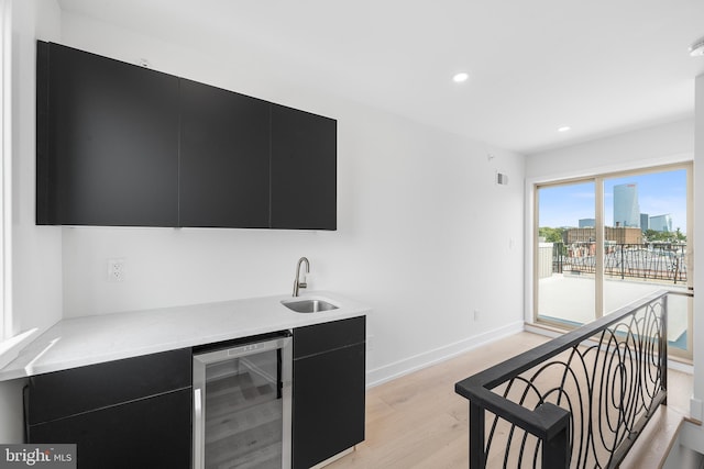 2340 Alter St, Philadelphia, PA 19146 - bar with light wood-type flooring, recessed lighting, a sink, beverage cooler, and baseboards