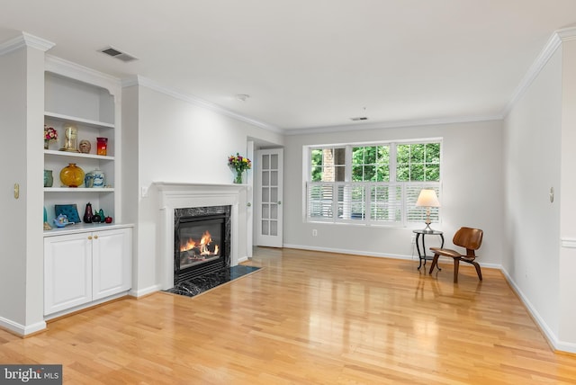12310 Rosslare Ridge Rd Unit 301, Lutherville Timonium, MD 21093 - living room with light wood-type flooring, a fireplace, ornamental molding, baseboards, and built in shelves