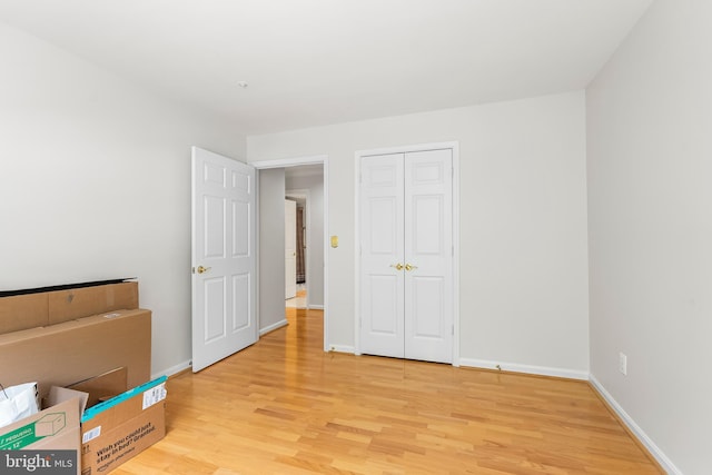 12310 Rosslare Ridge Rd Unit 301, Lutherville Timonium, MD 21093 - unfurnished bedroom featuring light wood-style flooring, baseboards, and a closet