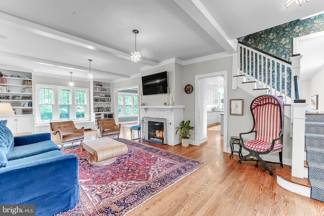 living room featuring stairway, wood finished floors, a fireplace, and baseboards