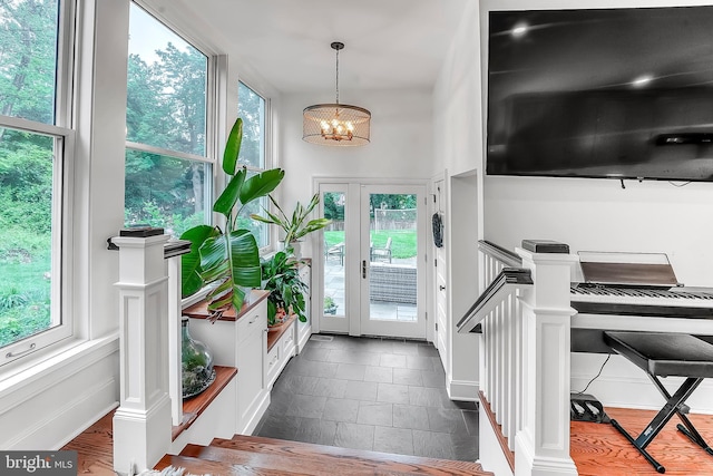 entryway with a chandelier and plenty of natural light