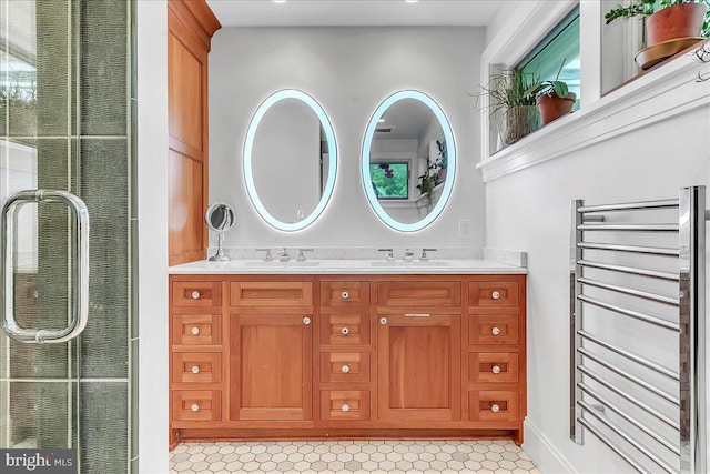 full bath featuring radiator and double vanity