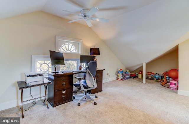 carpeted office with vaulted ceiling, ceiling fan, and baseboards