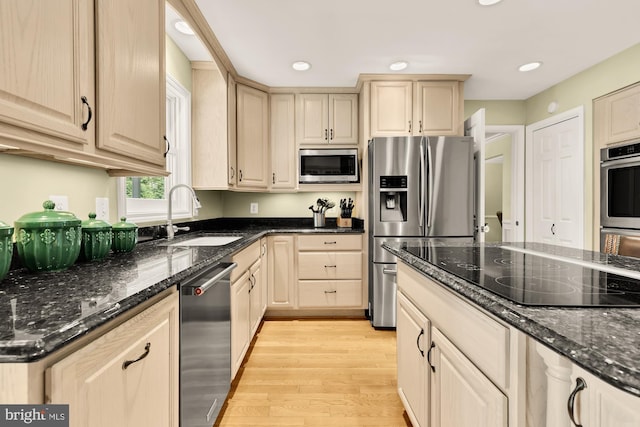 5117 Pheasant Ridge Rd, Fairfax, VA 22030 - kitchen with stainless steel appliances, a sink, light wood-style flooring, dark stone countertops, and recessed lighting