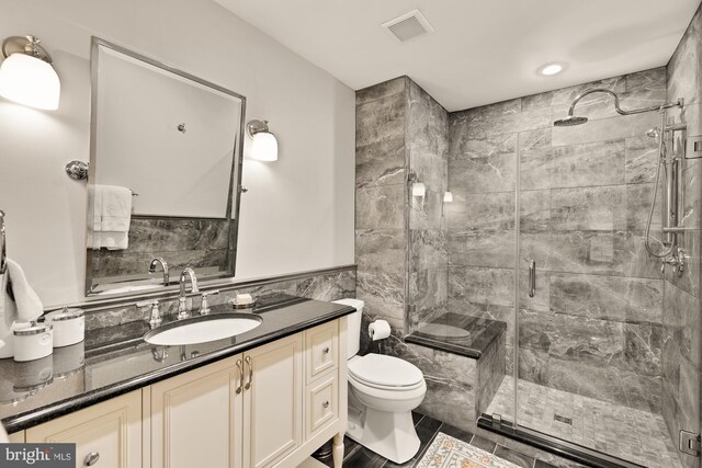 5117 Pheasant Ridge Rd, Fairfax, VA 22030 - bathroom with a stall shower, toilet, tile walls, vanity, and wainscoting