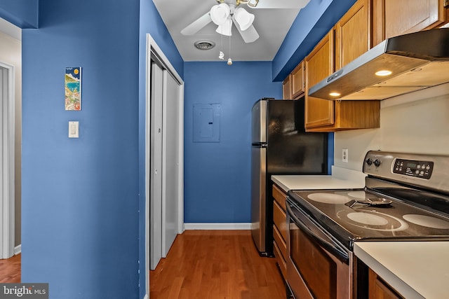 kitchen with visible vents, ceiling fan, under cabinet range hood, brown cabinetry, and stainless steel appliances