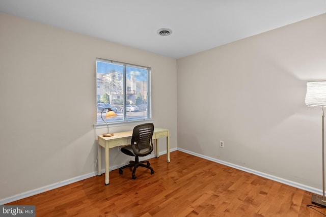 office area featuring visible vents, baseboards, and light wood-style floors