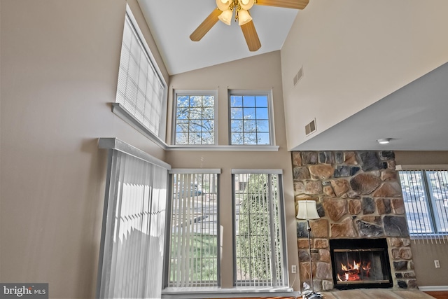 living area with visible vents, a ceiling fan, and plenty of natural light