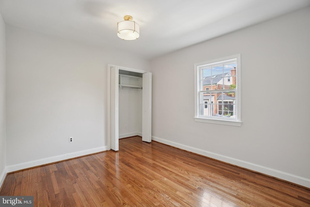 206 E Indian Spring Dr, Silver Spring, MD 20901 - unfurnished bedroom featuring baseboards, a closet, and wood finished floors