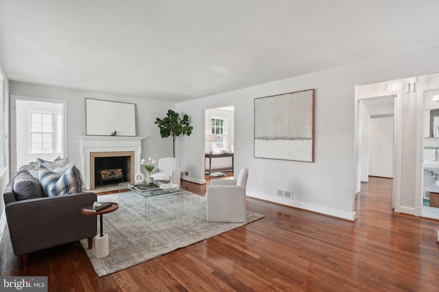 206 E Indian Spring Dr, Silver Spring, MD 20901 - living area with wood finished floors, baseboards, and a fireplace with flush hearth
