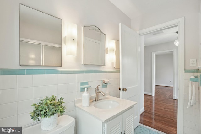 206 E Indian Spring Dr, Silver Spring, MD 20901 - bathroom featuring tile walls, vanity, a wainscoted wall, toilet, and wood finished floors