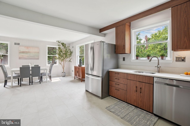 206 E Indian Spring Dr, Silver Spring, MD 20901 - kitchen featuring appliances with stainless steel finishes, a sink, light countertops, plenty of natural light, and beam ceiling