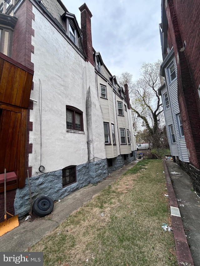6146 W Columbia Ave, Philadelphia, PA 19151 - view of side of home with a chimney and stucco siding