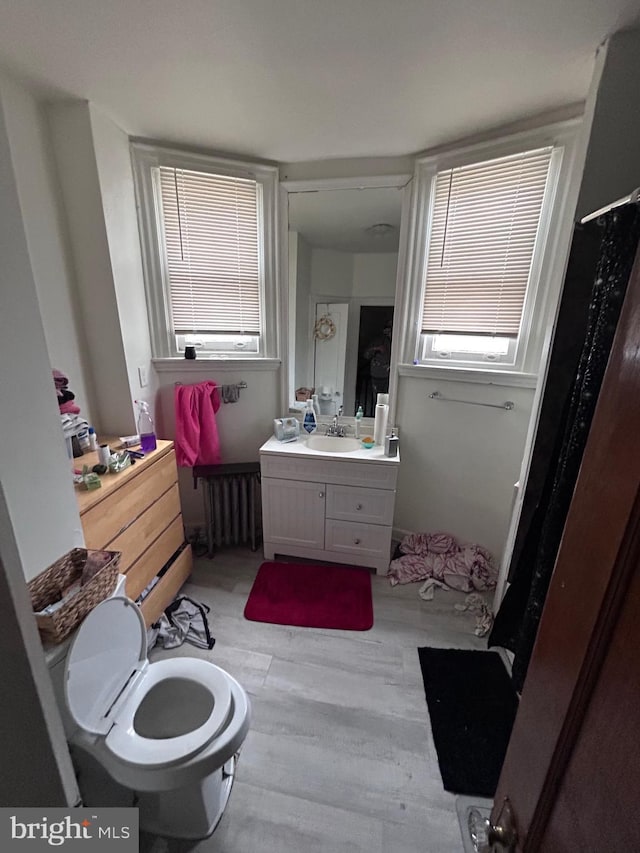 6146 W Columbia Ave, Philadelphia, PA 19151 - bathroom with radiator, vanity, and wood finished floors