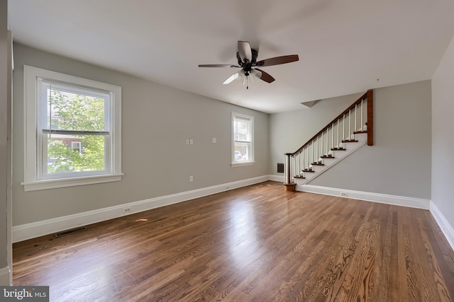 1221 Elm Ave, Lancaster, PA 17603 - unfurnished living room featuring plenty of natural light, stairs, a ceiling fan, and wood finished floors