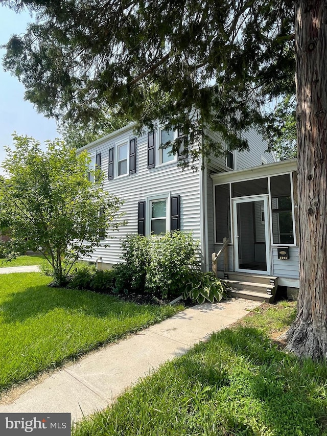 1221 Elm Ave, Lancaster, PA 17603 - view of front of house featuring a sunroom, a front lawn, and entry steps