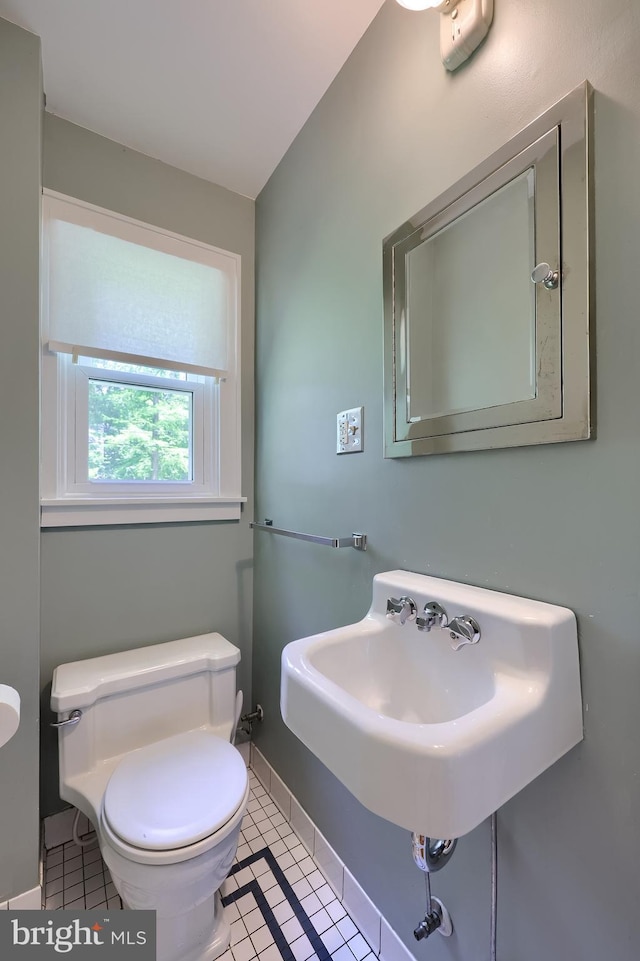 1221 Elm Ave, Lancaster, PA 17603 - half bathroom with toilet, tile patterned flooring, a sink, and baseboards