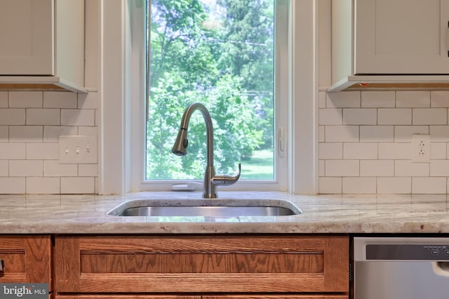 1221 Elm Ave, Lancaster, PA 17603 - kitchen with dishwasher, a sink, backsplash, and brown cabinetry
