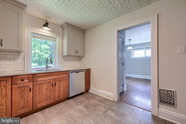 1221 Elm Ave, Lancaster, PA 17603 - kitchen with stainless steel dishwasher, a sink, tasteful backsplash, baseboards, and an ornate ceiling