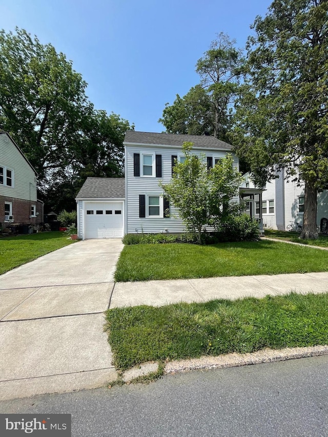 1221 Elm Ave, Lancaster, PA 17603 - view of front facade with driveway, a front yard, and an attached garage