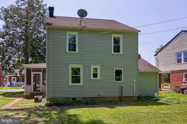 1221 Elm Ave, Lancaster, PA 17603 - rear view of house with a chimney, a lawn, a sunroom, central AC unit, and a shingled roof
