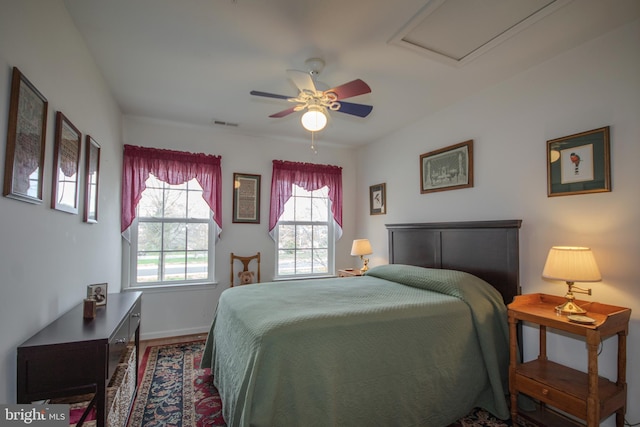 bedroom featuring visible vents, a ceiling fan, and baseboards