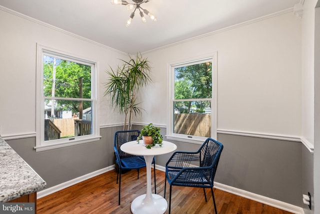 6002 Williamsburg Rd, Alexandria, VA 22303 - dining space featuring healthy amount of natural light, wood finished floors, crown molding, baseboards, and a chandelier