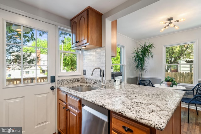 6002 Williamsburg Rd, Alexandria, VA 22303 - kitchen with a sink, stainless steel dishwasher, plenty of natural light, light stone counters, and crown molding