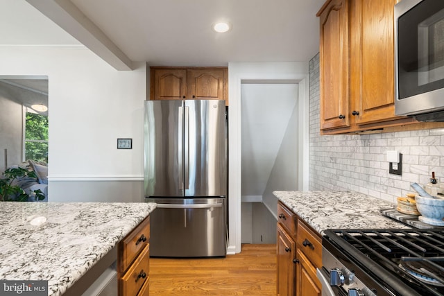 6002 Williamsburg Rd, Alexandria, VA 22303 - kitchen with stainless steel appliances, light stone countertops, light wood-style flooring, decorative backsplash, and recessed lighting