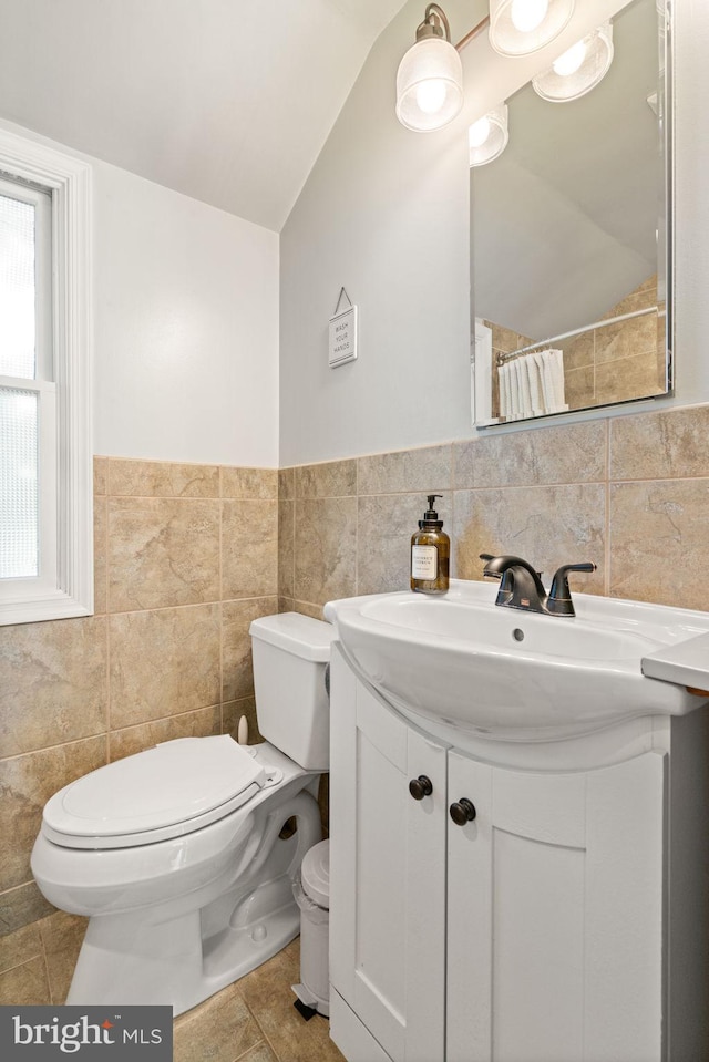 6002 Williamsburg Rd, Alexandria, VA 22303 - full bath with lofted ceiling, tile walls, vanity, toilet, and a shower with shower curtain