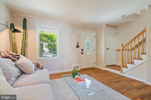 6002 Williamsburg Rd, Alexandria, VA 22303 - living room featuring wood finished floors, baseboards, stairway, and crown molding