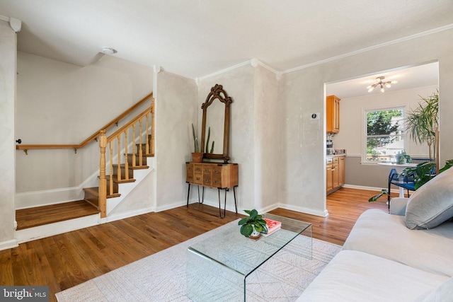 6002 Williamsburg Rd, Alexandria, VA 22303 - living area with wood finished floors, stairs, baseboards, crown molding, and a chandelier