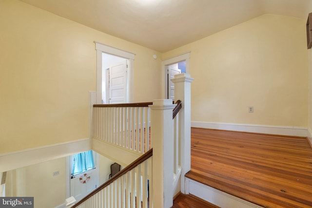 stairs featuring wood finished floors and baseboards