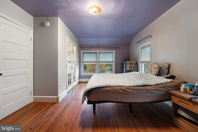 bedroom featuring wood-type flooring and baseboards