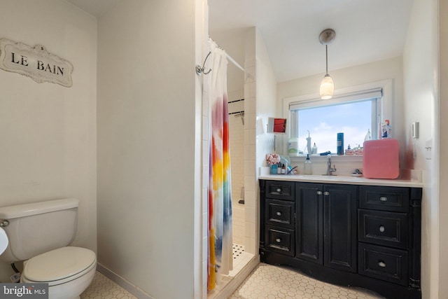 full bath featuring toilet, a stall shower, and vanity