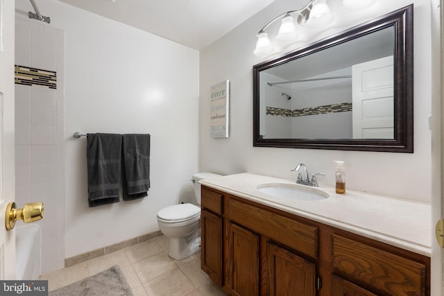 bathroom featuring vanity, tile patterned flooring, toilet, walk in shower, and baseboards