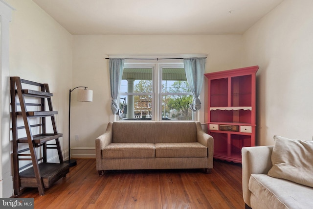 living room with baseboards and wood finished floors