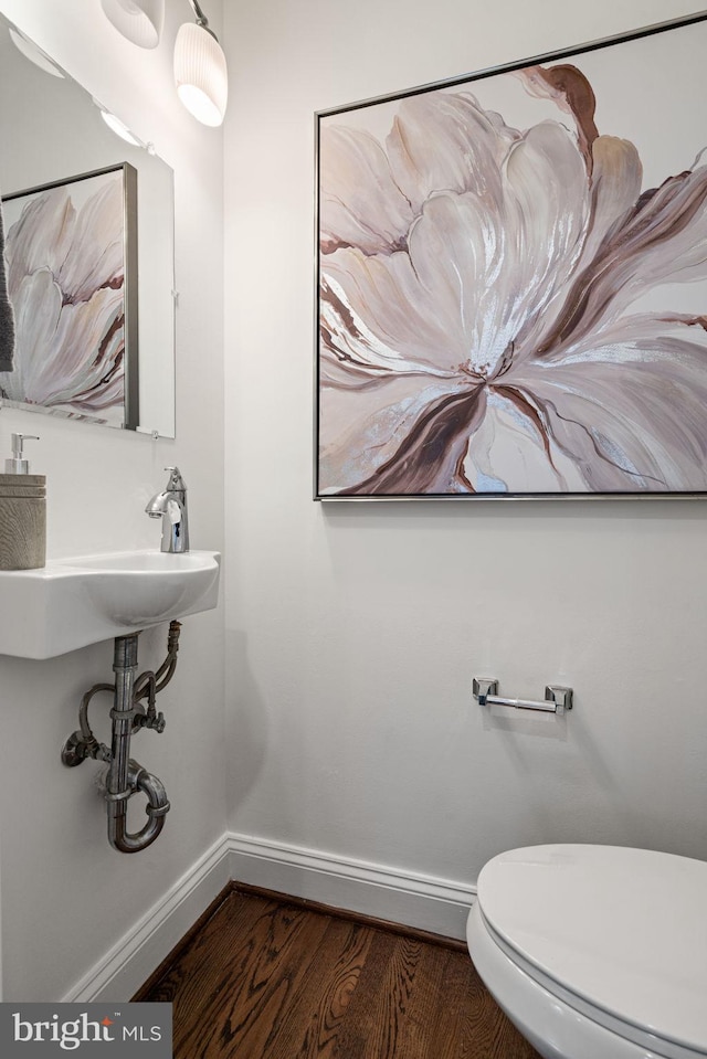 6005 Monticello Rd, Alexandria, VA 22303 - bathroom featuring baseboards, toilet, and wood finished floors