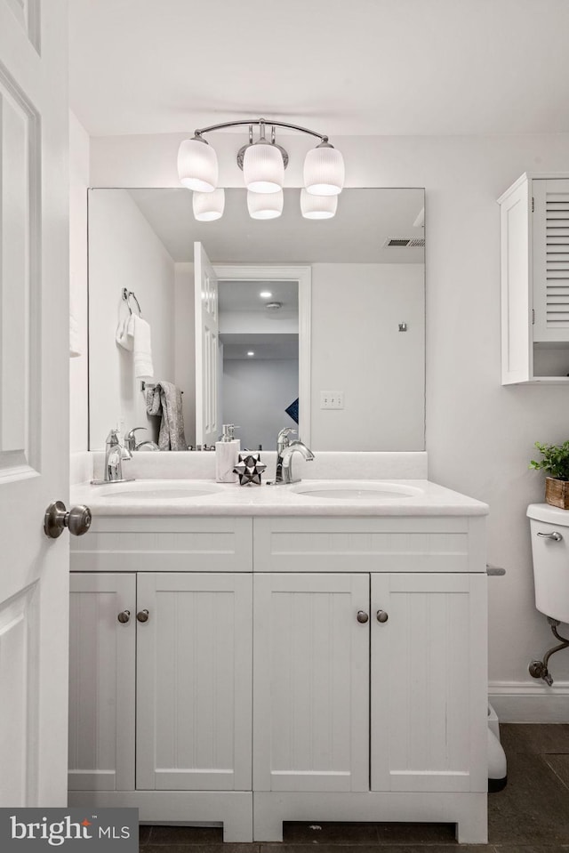 6005 Monticello Rd, Alexandria, VA 22303 - bathroom featuring toilet, double vanity, and baseboards