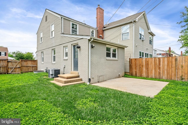 6005 Monticello Rd, Alexandria, VA 22303 - back of house featuring brick siding, cooling unit, a patio area, and a chimney
