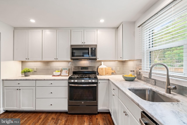 6005 Monticello Rd, Alexandria, VA 22303 - kitchen with stainless steel appliances, a sink, white cabinetry, backsplash, and recessed lighting