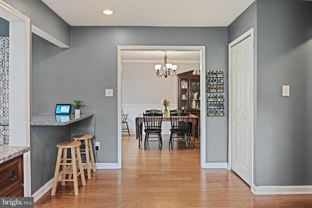 dining room featuring recessed lighting, baseboards, a notable chandelier, and light wood-type flooring