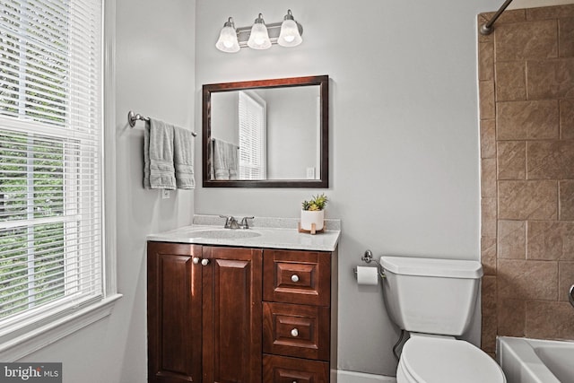 bathroom with shower / washtub combination, vanity, toilet, and a wealth of natural light