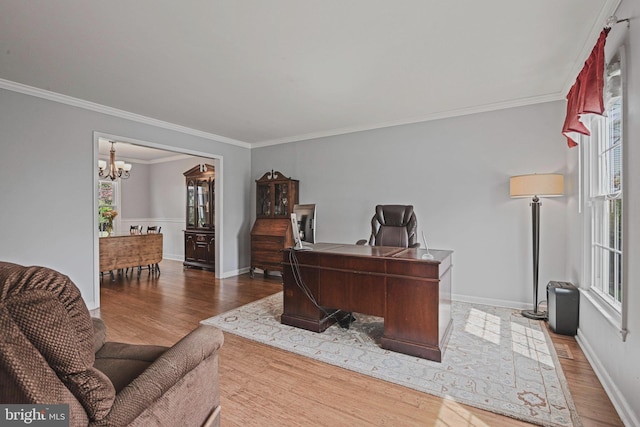 office with baseboards, an inviting chandelier, ornamental molding, and wood finished floors